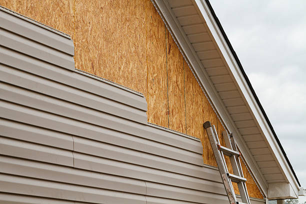 Professional Storm Damage Siding Repair technician working in Howard, PA